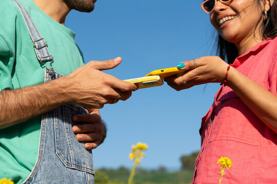 Couple sharing phone content yellow flowers
