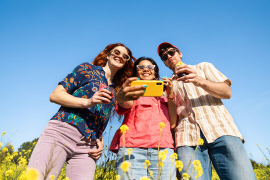 Friends Taking Selfie In Flower Field
