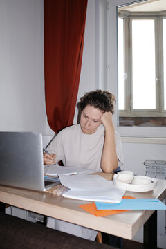 Person studying learning online with laptop at desk