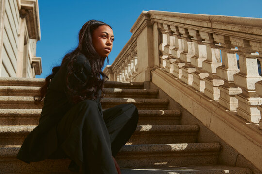 Woman wearing black on stair case 