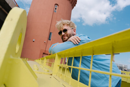 Low angle portrait of man on bridge