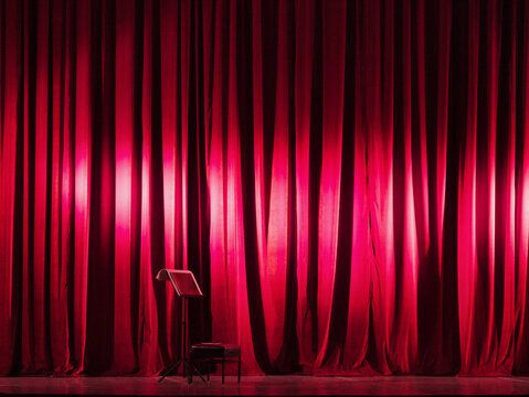 Empty Stage with Music Stand and Red Theatre Curtains