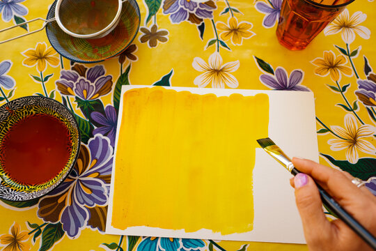 Hand Painting with Yellow Brush on Canvas
