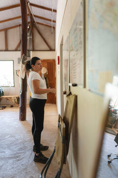 Woman planning trip on map and whiteboard