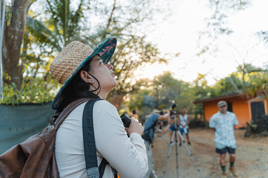 Woman with binoculars birdwatching discovering wildlife in nature