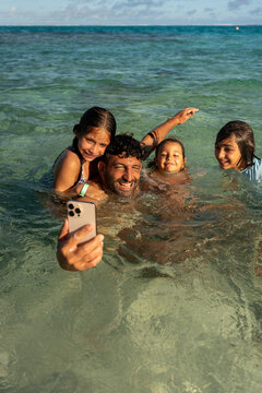 Family taking selfie in ocean water