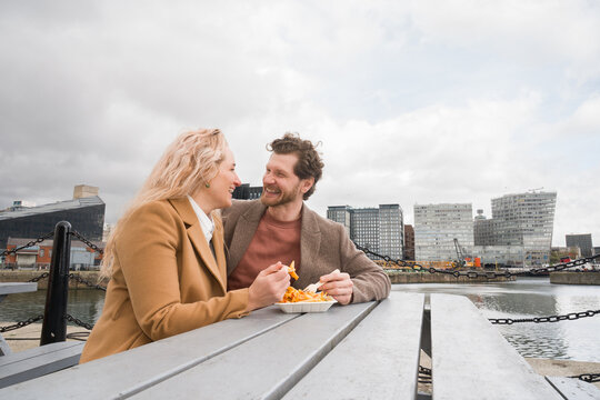 Couple Enjoys Fast Food Together At Liverpool Waterfront