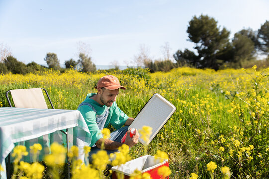 Man Preparing Picnic Cooler Outdoors
