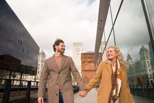 Couple Walk Hand in Hand in Liverpool Albert Dock