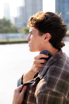 Man cooling neck with towel in intense heat outdoors