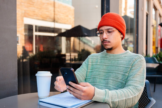 Man using phone at cafe