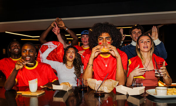 Friends cheering for his football team