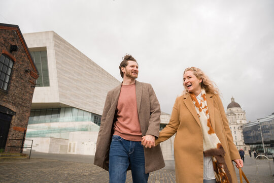 Couple Walk Hand in Hand in Liverpool Albert Dock Area
