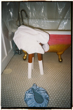 Towel and Laundry Near a Bathtub in a Bathroom Setting