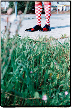 a man seen through grass wears fins outdoors, 35mm film