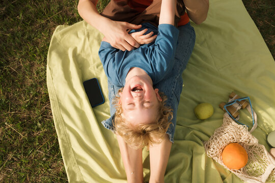 Family enjoys fun outdoor picnic on a sunny spring day
