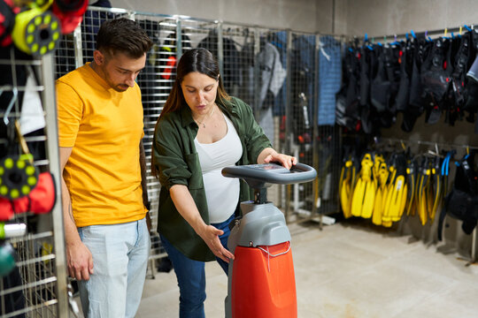People buying an underwater scooter at dive center