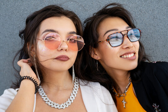 Close-up portrait of two stylish friends in trendy sunglasses