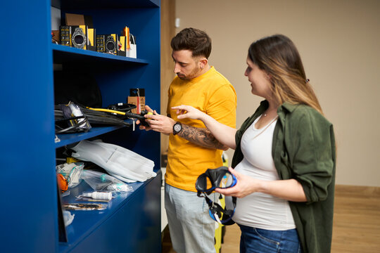 Pregnant woman and man shopping scuba gear