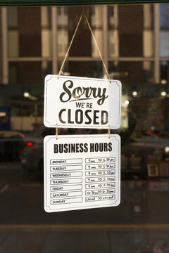 Closed Sign Hangs on the Window of a Business 