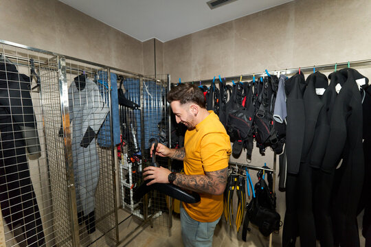 Man preparing scuba gear at dive center