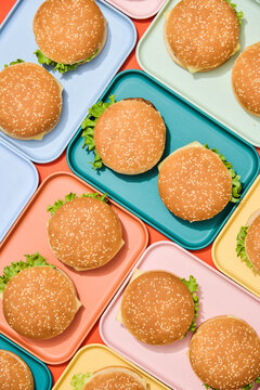 Burgers on Colorful Trays. Finger, fast food background. 