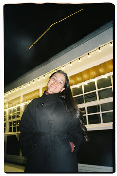 Smiling Woman Portrait with Lights at Night