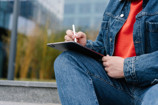 Writing on tablet outdoors