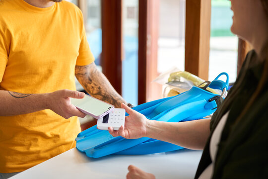 Customer checking out with dive equipment using contactless payment