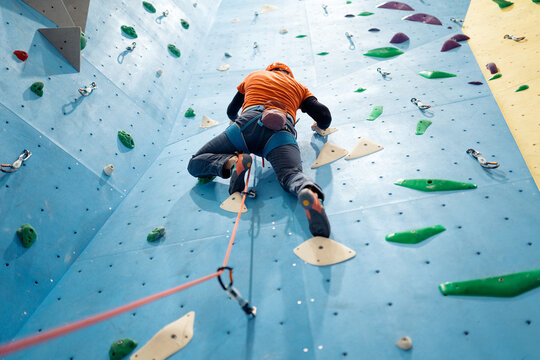 Person rock climbing indoors on artificial wall