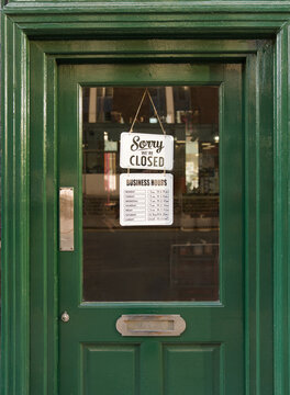 Closed Sign Hangs on the Door of a Business 