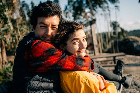 Couple Enjoys Time Together Outdoors Near Trees and Benches