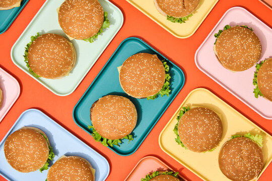 Burgers on Colorful Trays. Finger, fast food background. 