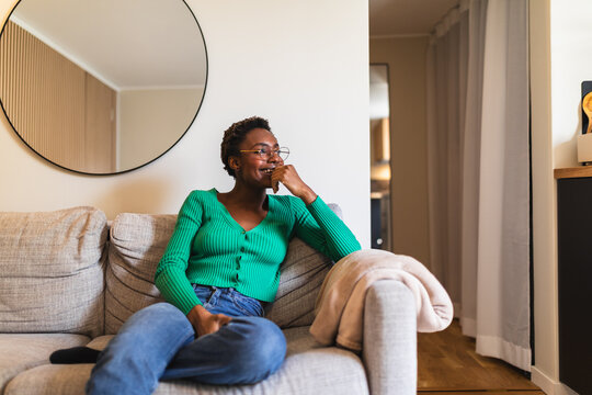Content Black Woman Relaxing on Living Room Couch