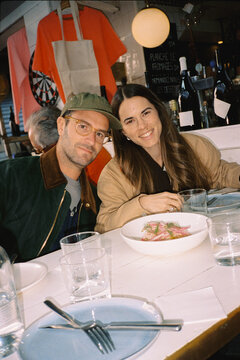 Portrait of couple of travelers posing at a local restaurant in Paris