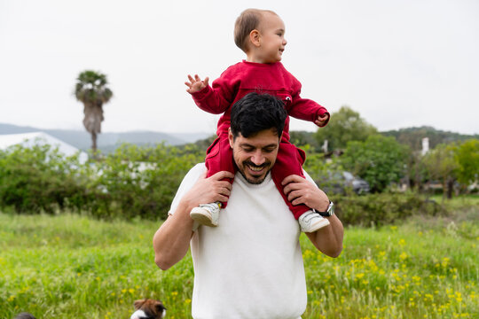 Father giving child a piggyback ride