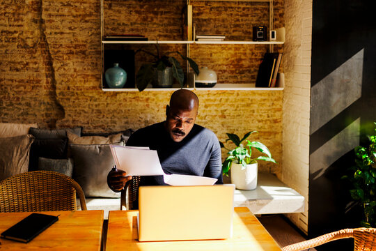 Man reviewing documents working from home remotely