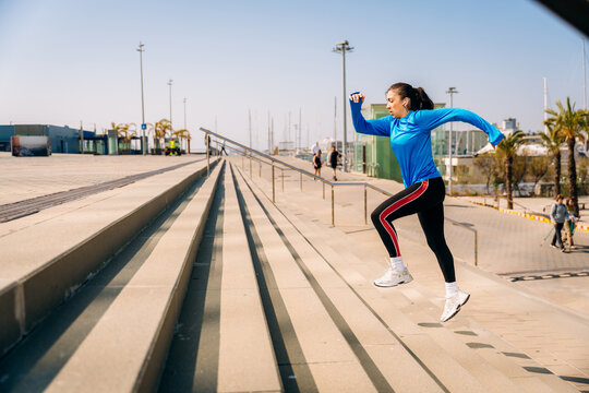 A woman does exercises on the stairs