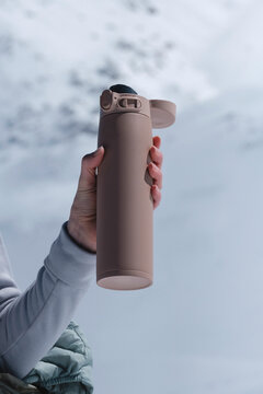 Close-up of a thermos in a snowy environment.