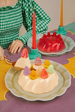 Close up of sliced creamy jelly cake dessert being cut with spatula