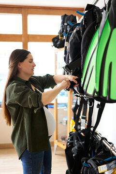 Pregnant woman checking scuba diving BCD gear