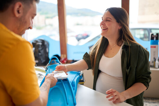 Pregnant woman purchasing flippers at a dive center