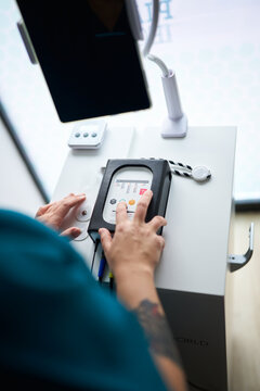 Person operating neurostimulation device at physiotherapy center