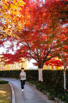 Happy boy running on park path 