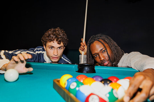 Men playing billiards enjoying a fun night out