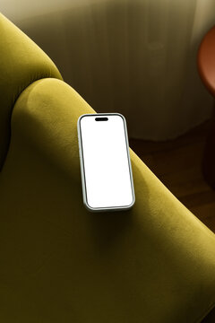 Mobile phone on couch with empty screen ready for use    
