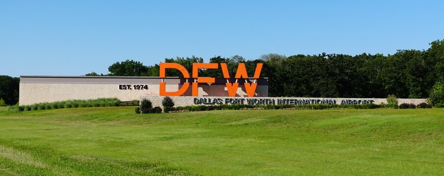 Northern Texas, U.S.A - May 31, 2026 - Stone monument sign displaying DFW and Dallas Fort Worth International Airport, established in 1974