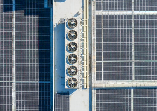 Factory Rooftop with Solar Panels and Cooling Units Aerial