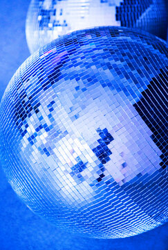 Disco ball in intense blue light closeup