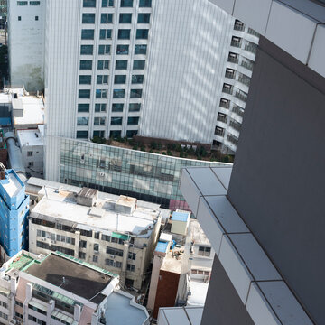 High Angle View of a Vintage Ivory Building Behind a Gray Tower